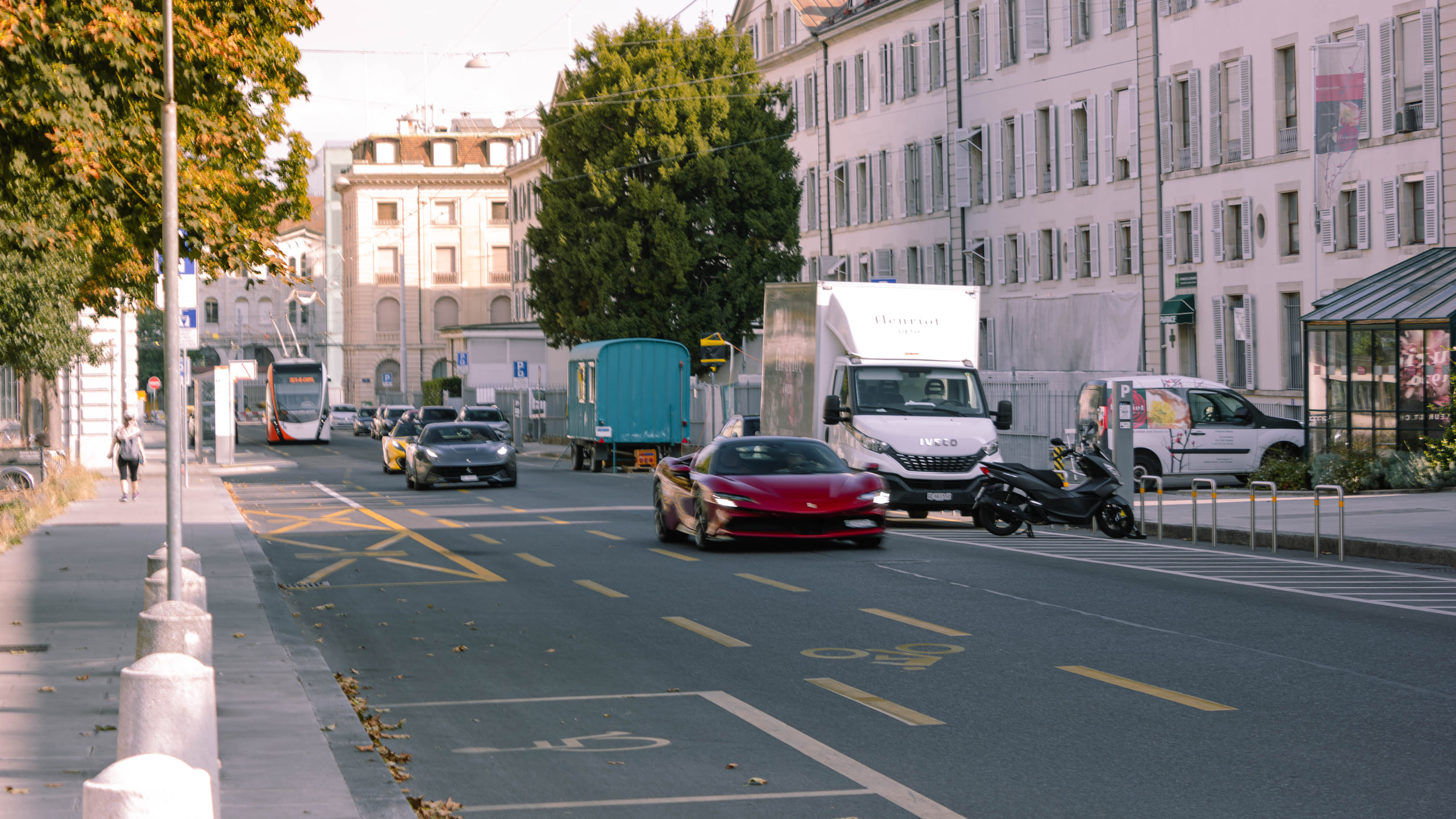 Red Ferrari driving through Geneva photographed by Dani Oncins Roca